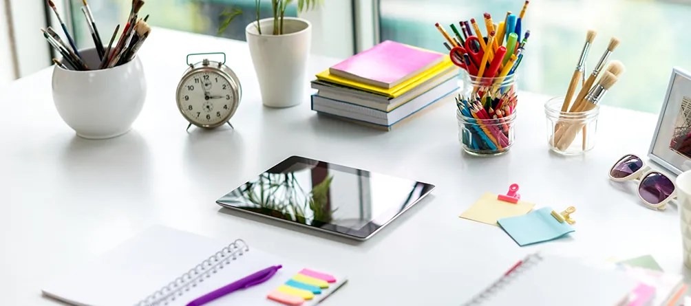 Tablet on table with various items