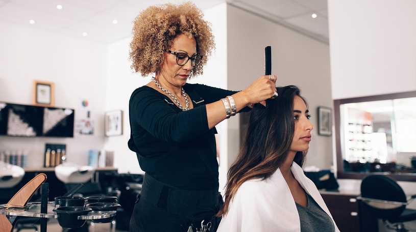 Hairdresser cutting hair in a salon