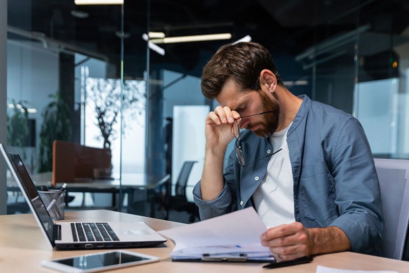 Stressed business owner looking at laptop