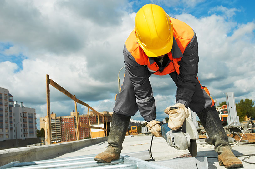 A builder uses a tool on a construction site