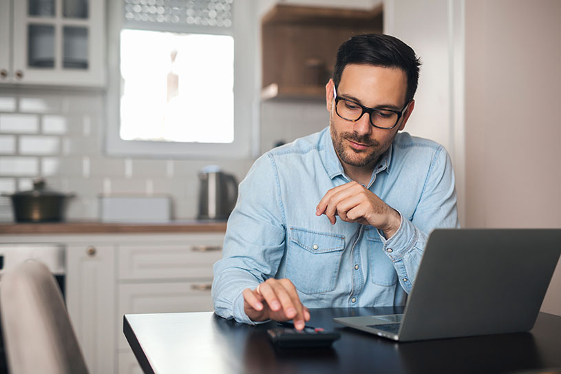 Small business owner works on calculator