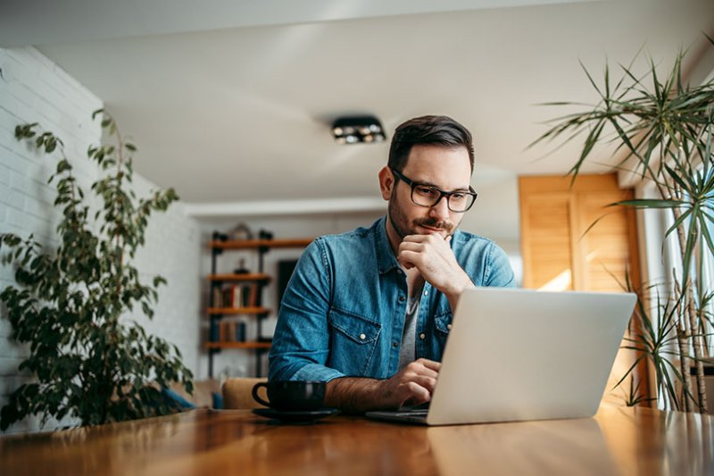 Man working on laptop to get a Confirmation Statement