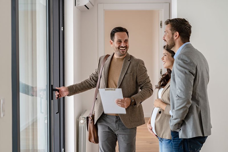 Tenants looking around a property with a letting agent