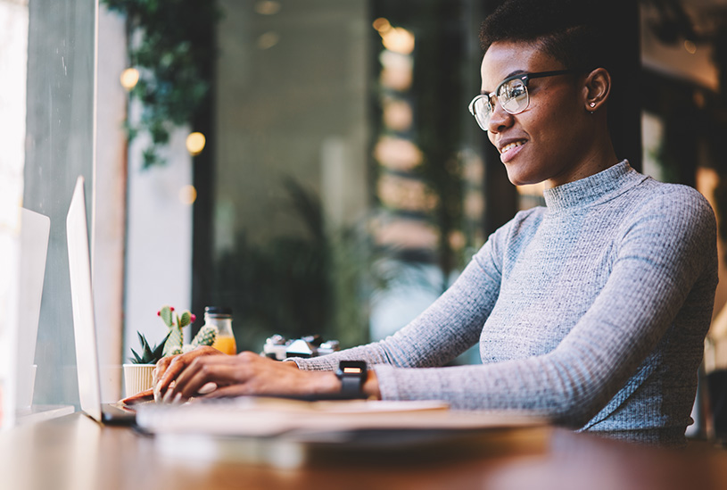 Businesswoman looking at invoice on her laptop