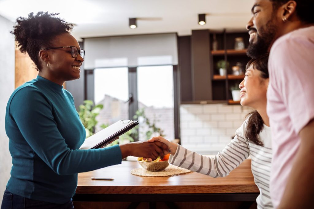 Landlord shaking hand with tenants