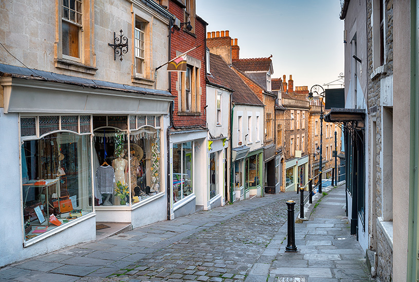 Cobbled UK high street showing shop units