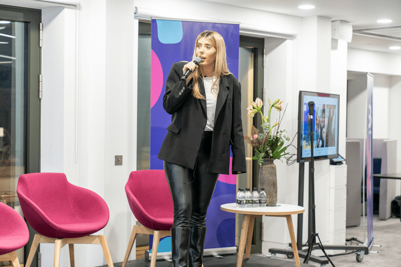 Lucy Hitchcock speaking on stage at women in business event