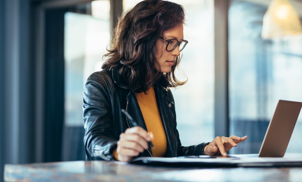 Business woman looking at balance sheet