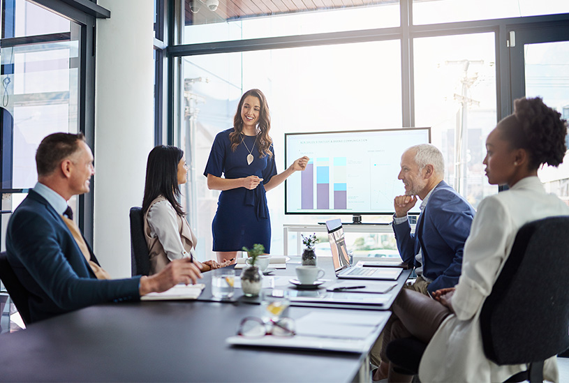 Business leaders looking at analytics in a meeting