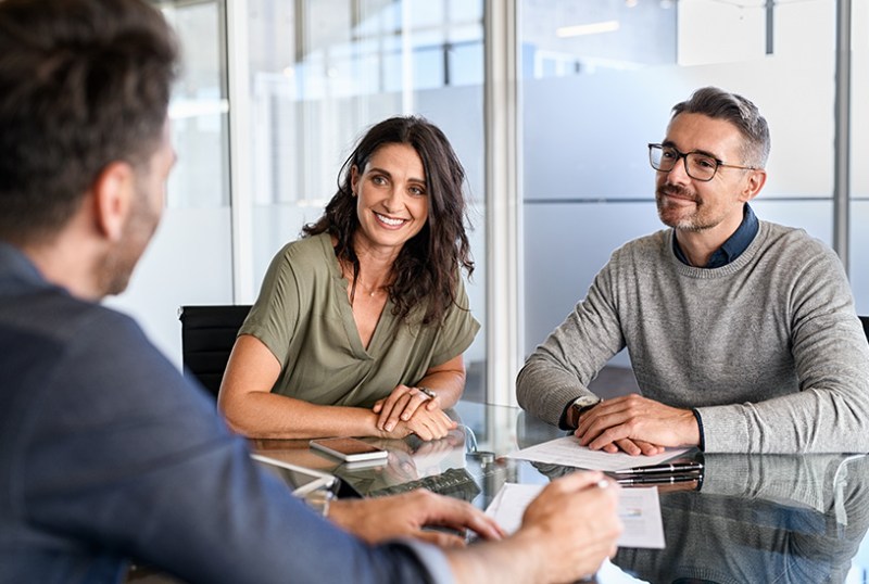 Couple speaking to mortgage advisor about a mortgage application