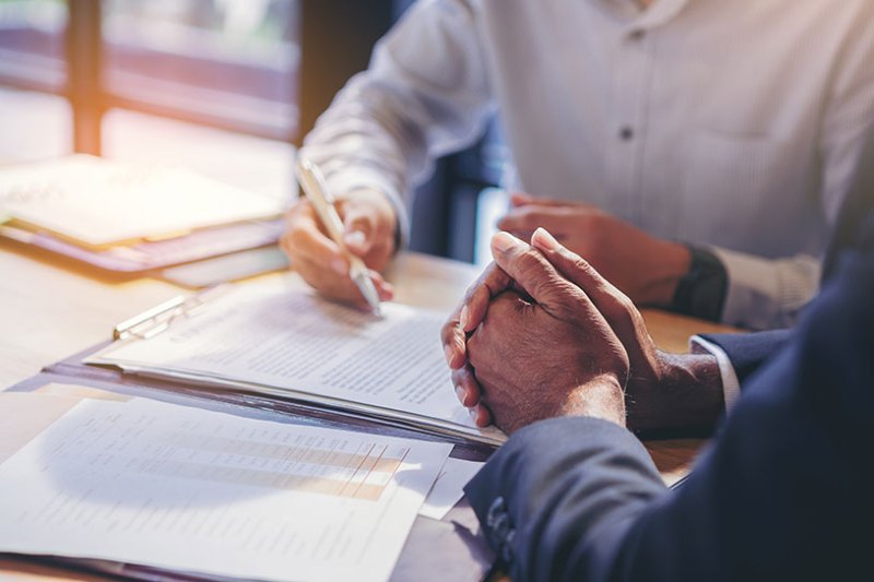 Two businessmen signing a confidentiality agreement