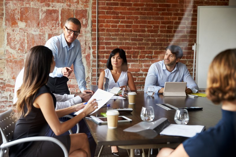 Business people in suits in a boardroom