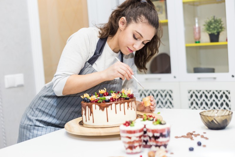 Home baker decorating a cake