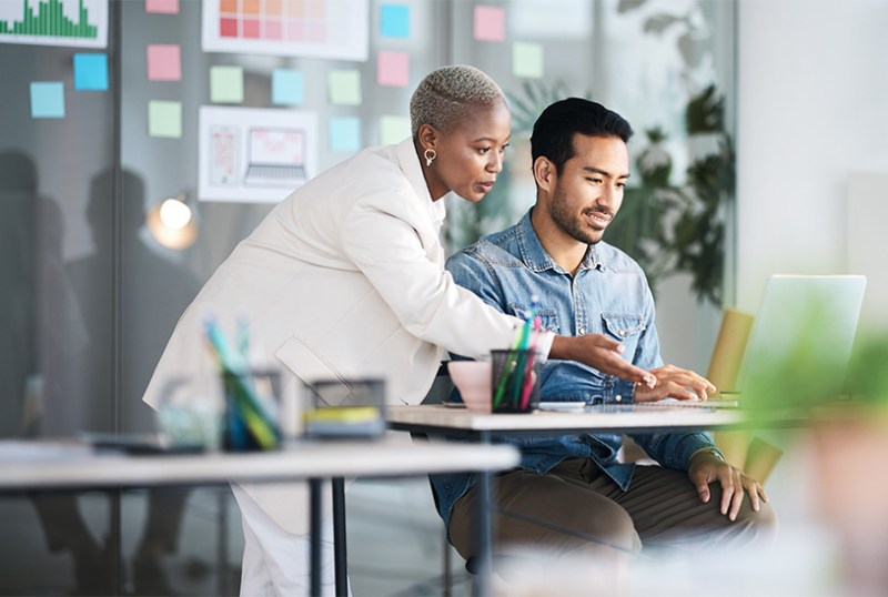 Business colleagues working together on a laptop