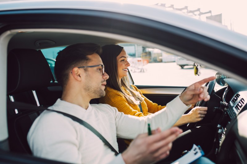 Driving instructor teaching a student