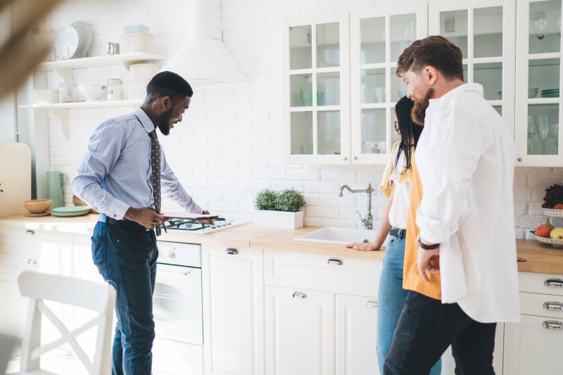 Man inspecting gas hob in rental property