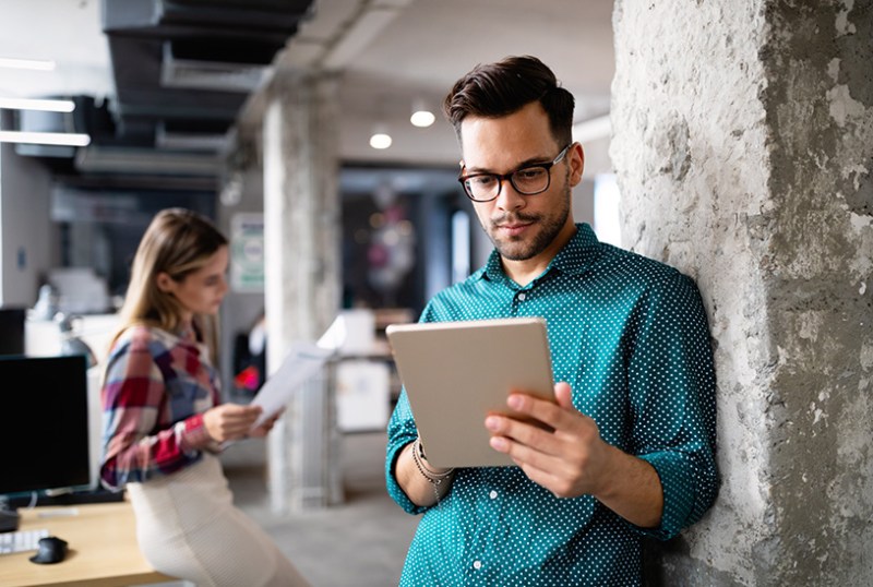 Business owner looking at tax records on tablet