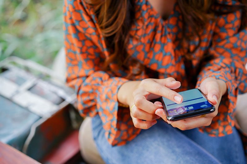 Woman using Facebook Business on smartphone