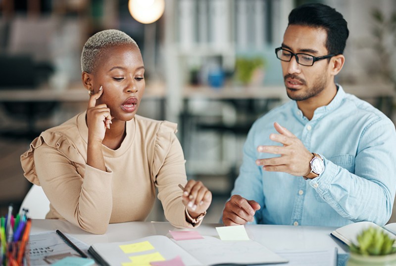 Business owner and employee having difficult work conversation