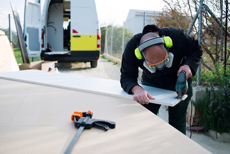 Tradesman working near van