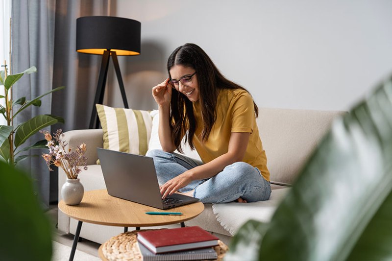 Young woman writing a blog on her laptop