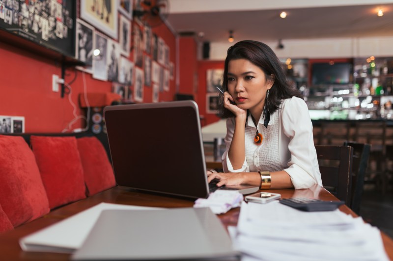 Woman studying laptop screen