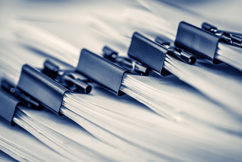 Close up of office papers neatly stacked in a pile