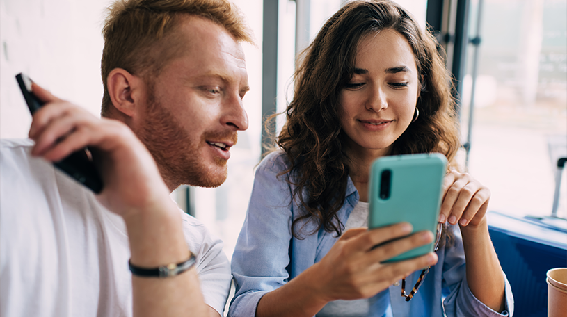 Male and female looking at an iPhone