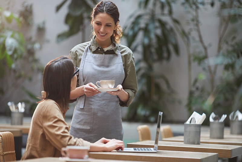 Waitress serving a customer in a cafe