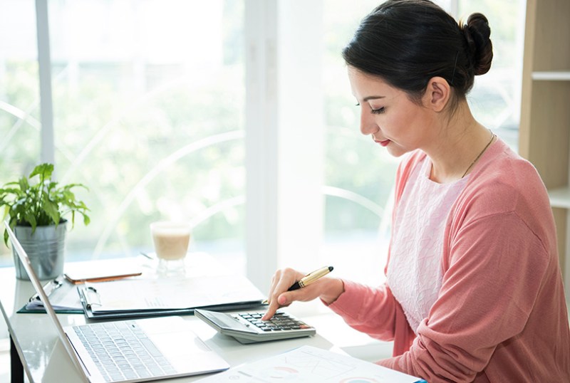 Landlord looking at calculator and mortgage costs