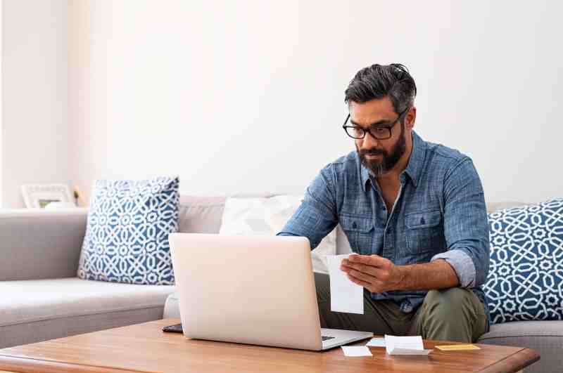 Man in glasses using laptop