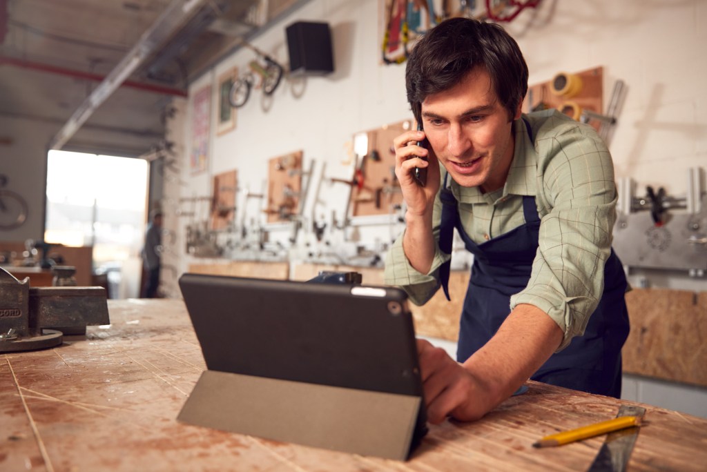 Business owner in a workshop on the phone