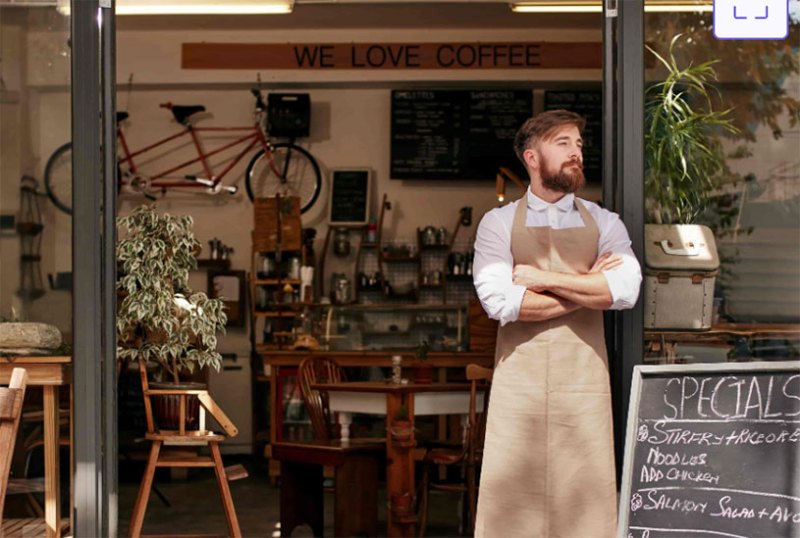 Man standing at entrance to coffee shop