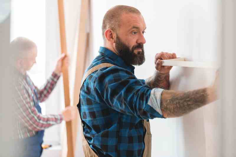 Tradesman checking the level of a wall