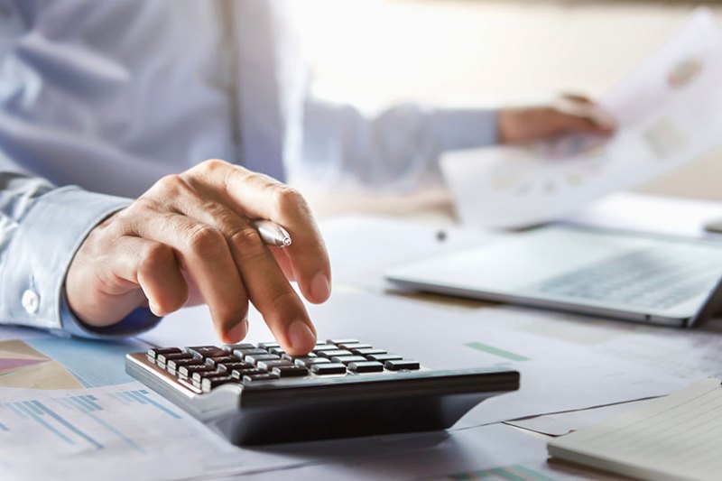 A business owner working out their finances on a calculator