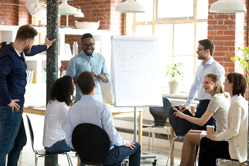 Smiling man leading a business meeting