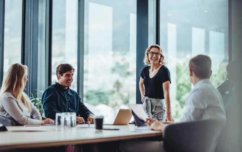 Four people in a boardroom meeting