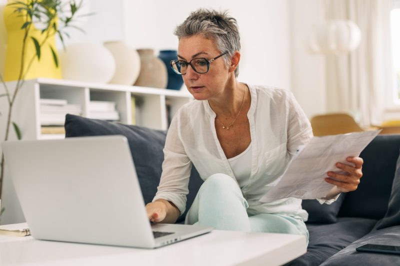 A woman looks at her taxes at home.