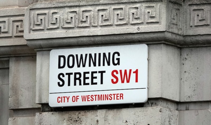 Downing Street sign on a wall.