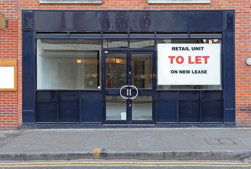 Empty shop with to let sign in the window