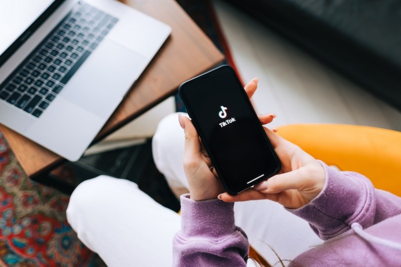 In the face of a US TikTok ban, a woman checks the app on her phone.